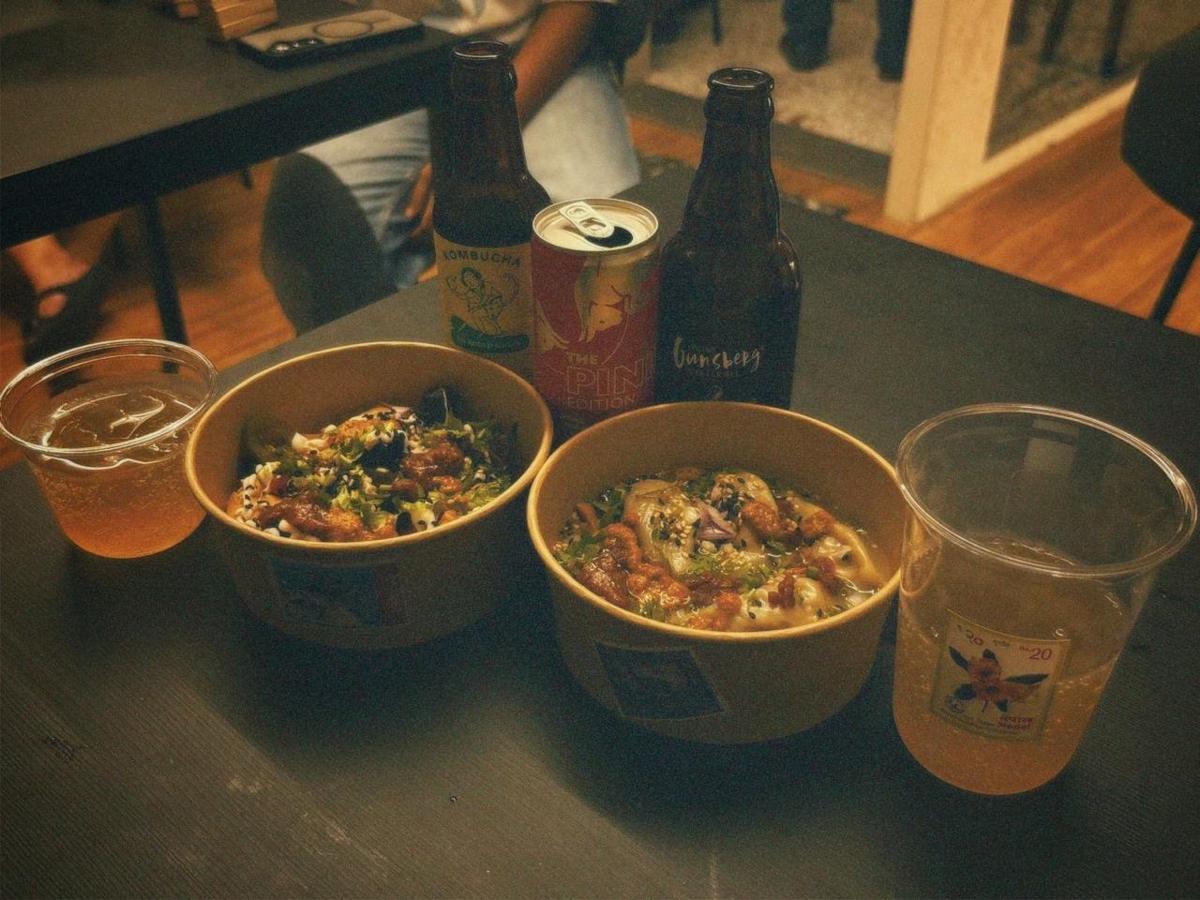 A table of momo bowls, kombucha and cold drinks